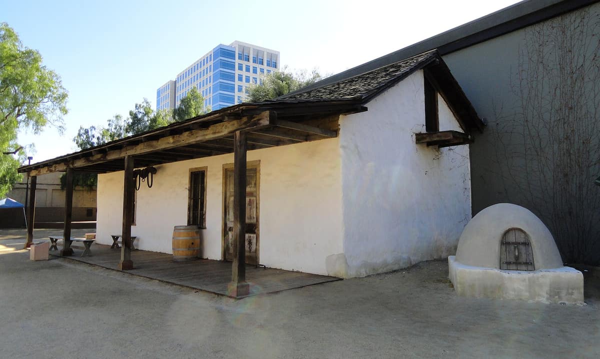 The whitewashed walls and tile roof of the Peralta Adobe, built about 1797