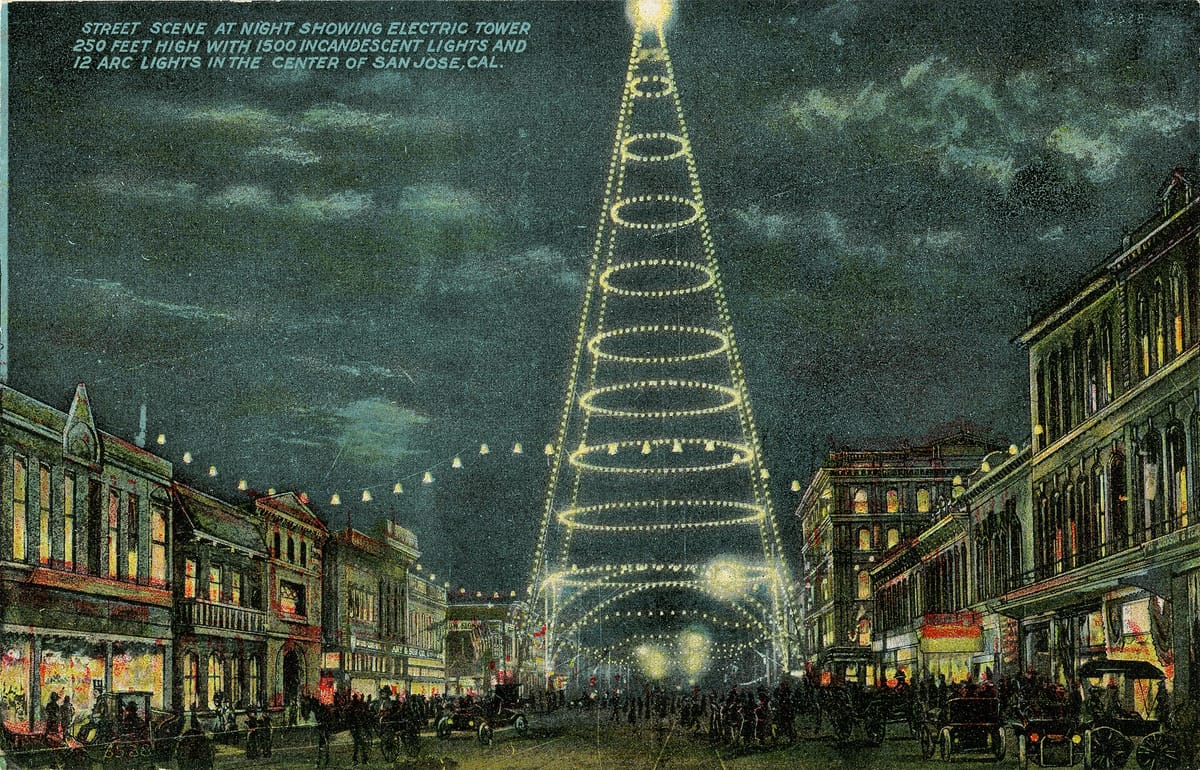 An old postcard of the electric light tower lit up over a San Jose street at night
